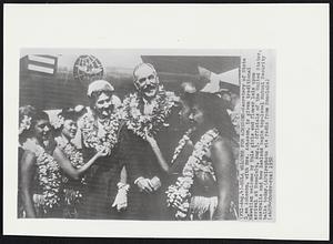Hula Welcome for Achesons- Secretary of State Dean Acheson, with Mrs. Acheson, is given traditional Hawaiian welcome by Hula girls and flower leis upon arrival in Honolulu, Aug 3. Officials of the United States, Australia and New Zealand begin top-level Mutual Security talks today.