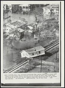 Await Evacuation from Camille Winds--Five person await rescue on rail tracks between Gulfport and New Orleans as there large frame house was lifted by the 150 miles an hour winds of hurricane Camille and left on the tracks high and dry.