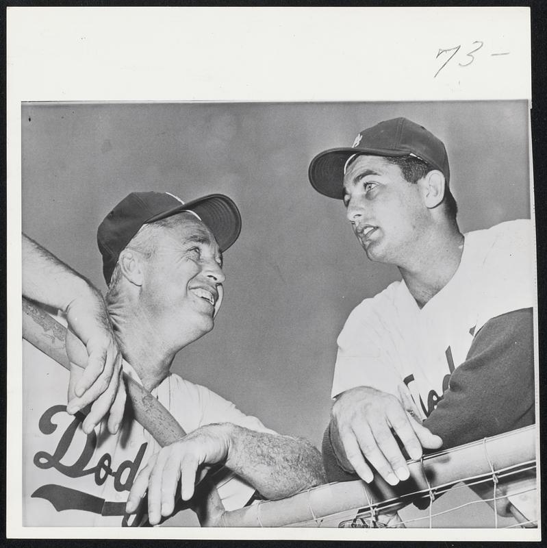 Los Angeles Manager and relieving star pose as the Dodgers await the sixth game of the World Series with the Chicago White Sox. Manager Walter Alston (left) smiles at 24-year-old Larry Sherry, who won one game and saved the other two for the Dodgers.