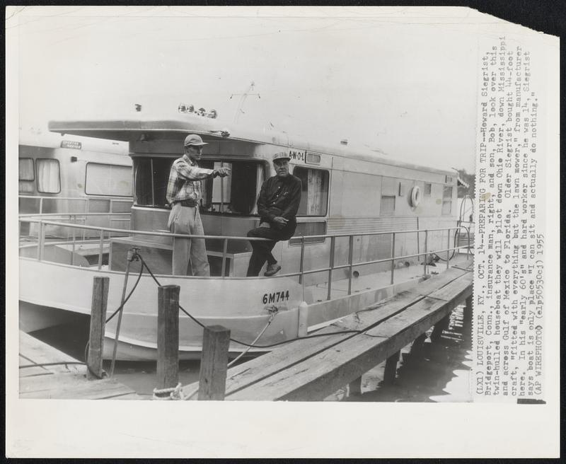 Louisville, KY – Preparing For Tip – Howard Siegerist, Bridgeport, Conn., insurance man, right, and son, Bob, look over this twin-hulled houseboat they will pilot down Ohio River, down Mississippi and across Gulf of Mexico to Florida. Older Siegrist bought 44-foot craft, “fitted with everything but the lawn mower,” from manufacturer here. In his “early 60’s” and hard worker since he was 14, Siegrist says boat is only place “I can sit and actually do nothing.”