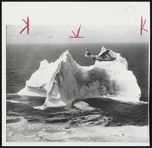 Coast Guard plane from Argentina circles an iceberg off the coast of Newfoundland, checking 150-foot high ice cliff. The vessel is part of the International Ice Patrol in the North Atlantic.