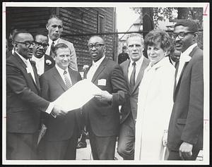 Gov. Volpe stands between official charter during yesterday's ceremony Harold L. Vaughan, a director, Volpe, Donald E. Sneed Jr., and president, Mayor White, state Banking Commr. Freyda and T. Hayden, who first thought of building the bank. In rear are, left Charles Lewis Jr., a director, and Lt. Gov. Francis Sargent.