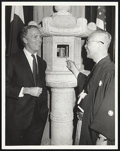 Lighting candle in Japanese stone lanterns. L-R Mayor Kevin White and Mayor Kyoshi Tomii of Kyoto, Japan