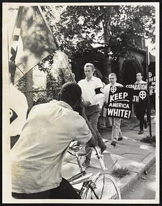 Prejudice Around the World. Undated: No person who ever lived, including the most venerated of saints, has ever been free of prejudice. Here, as a Negro watches from a bike, members of the segregationist American National Party carry signs saying "Whites Have Rights Too" and "Keep America White" at an integration rally in Englewood, N.J., in this 1965 file photo.