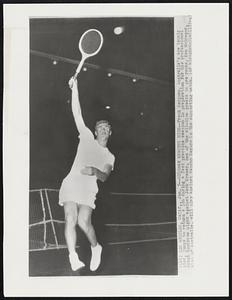 Sedgman Reaches High--Frank Sedgman, Australia's ace tennis star, jumps to return a lob during a fast practice session in preparation for his professional debut tomorrow night against Jack Kramer, one of the all-time greats in pro ranks. Ken McGregor, also of Australia, will play against Pancho Seguro in the supporting match.