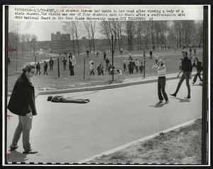 A student throws her hands to her head after viewing a body of a slain student. The victim was one of four students shot to death after a confrontation with Ohio National Guard on the Kent State University campus.