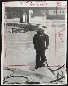 Diver Retrieves Truck from the flooding Mississippi river at St. Louis. He is Charley Delps, photographed as he emerged from the water after securing a tow rope to a submerged truck.