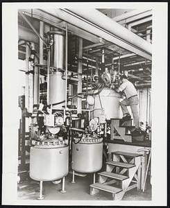 The Rodney Hunt Turba-Film Evaporator (vertical column at center left of photo) at the Nutley Park, New Jersey, plant of Hoffman-LaRoche, Inc., where it is being used for processing heat-sensitive pharmaceuticals.