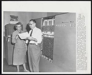 Electronic Weather Computer--Newton C. Stone (right), vice president of Irving P. Krick Associates, Denver, explains a weather chart to Evelyn Reece, who will operate the electric computer in background which, company president Dr. Irving P. Krick said in Dallas, Tex., yesterday, is part of a radical new weather forecasting system which soon will permit daily weather predictions "for several years in advance."