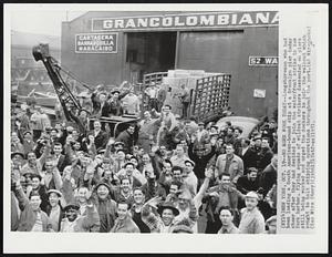 New York -- No More Work Today -- Longshoreman who had been loading a South American-bound ship at a Brooklyn pier today cheer after they had decided to join the waterfront strike in New York harbor. Flying squads of wildcat strikers descended on piers still being worked and urged the dockers to join the walkout which sought to halt shipping operations throughout the port.