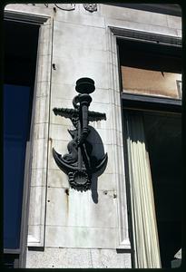 Building decoration depicting an anchor, a seahorse, a seashell and a torch