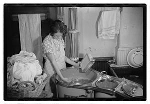 A woman doing laundry with a washing machine