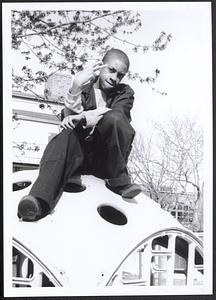 Boy sitting on playground equipment