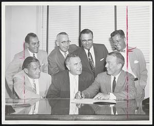 Lincoln-Mercury Dealers who yesterday signed up to sell the Continental Mark II, the Ford Motor Company’s new luxury car, in the office of J. F. Abely, seated center, Boston district sales manager, were, left to right, Edwin B. Holmes of Holmes Motors, Inc., Waltham; Loren C. White of Clark & White, Inc., Boston, and standaing, Frank C. O’Neill of O’Neill Motors, Inc., Wellesley; John T. Stokes of Bonnell & Stokes, Inc., Arlington; C. F. Tassinari of Fore River Motors, Inc., Quincy, and Frank J. Owen of Owen Motors, Inc., Westwood.