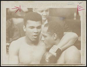Champion Cassius Clay (L) hugs challenger Zora Folley after knocking him out in the 7th round of their heavyweight title fight 3/22.