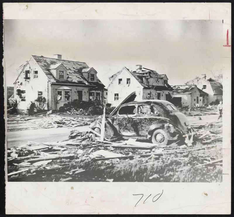 Paul Street, Worcester, after the tornado struck. The car was blown around like a child's toy, all houses in the section were damaged, and trees were blown down.