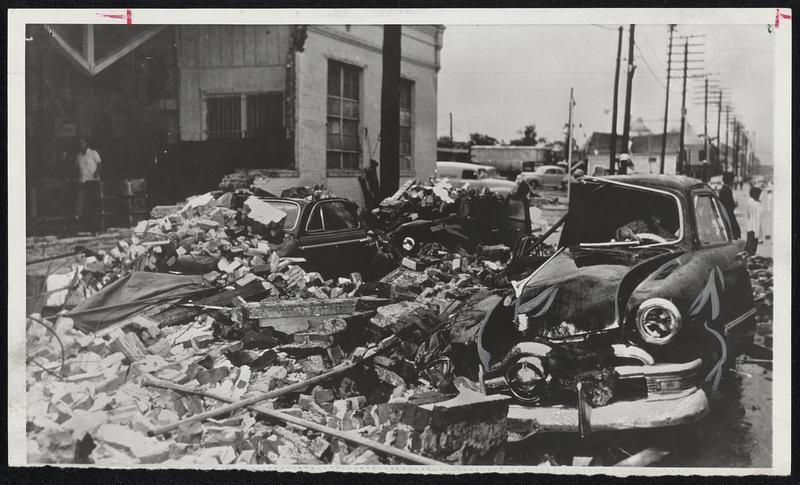 Motorists Caught on Street as Storm Strikes-The driver of the auto at right was one of many caught unawares as a tornado struck the downtown area of Waco, Texas, Monday. Autos at left were parked at the curb.