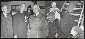 London Take-Off--Members of the Governor's party at the Bedford Airport just before their departure for London to plead that Boston be made the home of the United Nations Organization. Left: John Lynch of the Boston Traveler, Orson Adams, Jr., and Dr. Karl T. Compton. Right: Gov. Tobin says goodbye to Mrs. Tobin while his daughters, Louise (rear) and Carol Ann (lower right) look on.