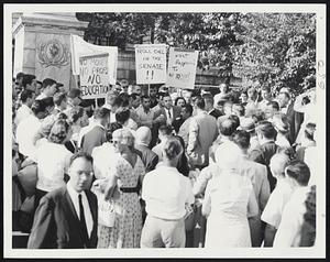 Furcolo Meets Students--Gov. Furcolo meets a group of placard waving University of Massachusetts students at the Hooker entrance to the State House. He hinted there may be another legislative attempt to win pay raises for the university's teachers. Students drove here in a motorcade from Amherst.