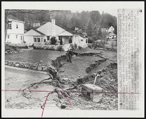 Costly 'Terracing'-Leaders of the Meadowdale Beach community, 20 miles north of Seattle on Puget Sound, estimate slide damage to 50 homes and yards may amount to as much as a million dollars. K.E. Northfield (above) surveys drop-away in his yard. Slides followed recent heavy rains. Some houses were wrecked. Some others have been abandoned.