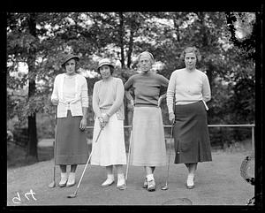 Four female golfers
