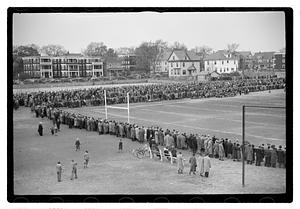 Crowd surrounding a football field