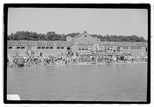 People in swimsuits by the water