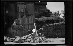 Rebuilding the big wall, 42 Highland Ave. Roxbury, Mass., part of new wall at the left, Mr. James Mulvey in the picture