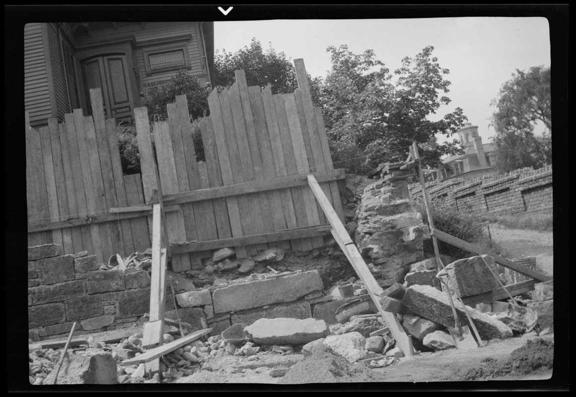 Rebuilding the big wall, 42 Highland Ave. Roxbury, Mass., nearing the corner, part of completed wall at left of picture