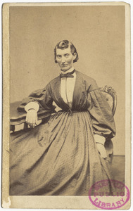 Frances L. Clalin in a dress, sitting