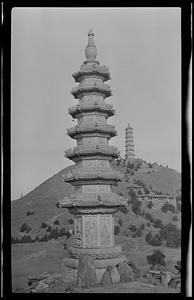 Marble pagoda with jade fountain on hill in background