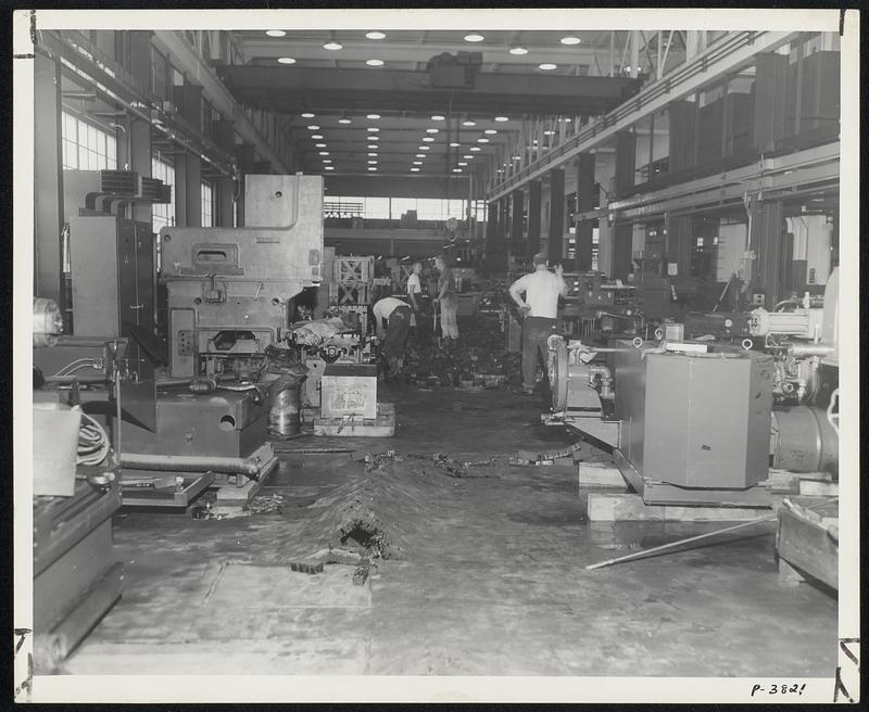 Wood block floor throughout Reed-Prentice plant lifted when swollen by flood waters.