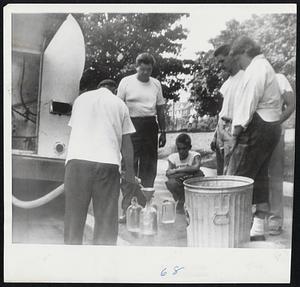 Water line in Connecticut- Residents of Torrington line up for fresh water at tank truck. Torrington was one of hardest hit of Connecticut cities during recent flood.