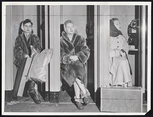 Waiting For Trains was a long, long process at both North and South stations yesterday. Above, waiting was all that Claire Lescard, Mrs. Ann Kelly and Shirley Taylor (left to right) could do until their train finally left for Lowell. Below is South Station concourse jammed for second straight day. B.& A. derailment near Huntington station caused part of jam.