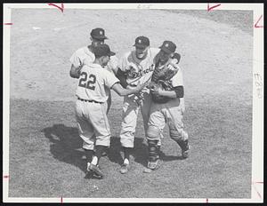 Excited Teammates gather around Detroit's Jim Bunning to offer congratulations after no-hitter against Red Sox at Fenway Park. Left to right, Ossie Virgil (22), Gail Harris, Bunning and his batterymate, Red Wilson.