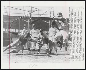 Lessons From an Old Hand-Veteran catcher Andy Seminick lunges for ball during demonstration to rookie receivers in how to go after a bad pitch at opening of Philadelphia Phillies rookie camp today. Making like a batter getting out of the way is rookie backstop Joe Lonnett of Beaver Falls, Pa. Watching, left to right, are Dick Harris of Los Angeles, Calif., Jim Coker of Holly Hills, S.C., Coach Benny Bengough and Mac Burke of Houston, Texas. Seminick is acting as a coach at the school.