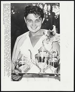 Silver Lining of Rain-Spotted Tournament-Rene Schuurman of South Africa holds winner's prize of a silver set after winning Eastern Grass Court Women's Championship here today. The 19-year-old tennis player upset fellow South African, Sandra Reynolds, 6-4, 1-6, 6-1, to capture her first U.S. tournament title. The final also marked the first all South African final in the tournament's history. Intermittent rain caused several delays in tournament.