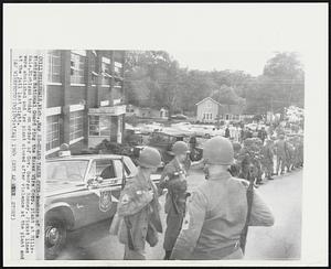 Hillsdale, Mich. -- Guard Takes Over -- Members of the Michigan National Guard ring the Essex Wire Corp. plant at Hillsdale, Michigan today on orders of Gov. George Romney. Picket lines were abolished and the plant closed after violence at the plant and at the jail last night.