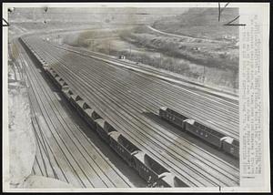 Williamson, W. VA -- Lots Of Cars But No Coal -- A mile-long string of empty coal cars stands by in the huge Norfolk & Western yards near here. The cars arrived yesterday as the walkout of United Mine Workers began to paralyze operations in West Virginia coal mines.