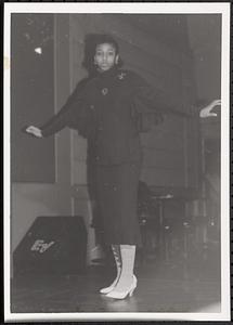 Young woman posing in a skirt and jacket