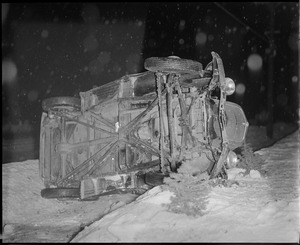 Car flips on to side in the snow