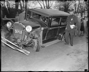 Police officer with wrecked auto