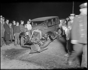 Man next to wrecked auto