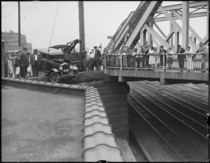 Truck almost goes off bridge over RR tracks
