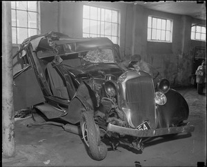 Wrecked auto in garage