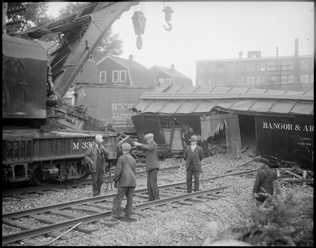 Crane on tracks clearing Bangor & Aroostook freight cars