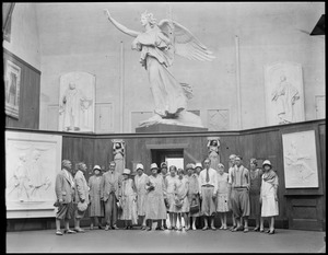 Group portrait under unidentified sculpture