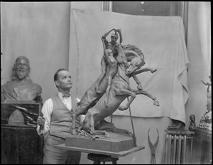 Sculptor working in studio