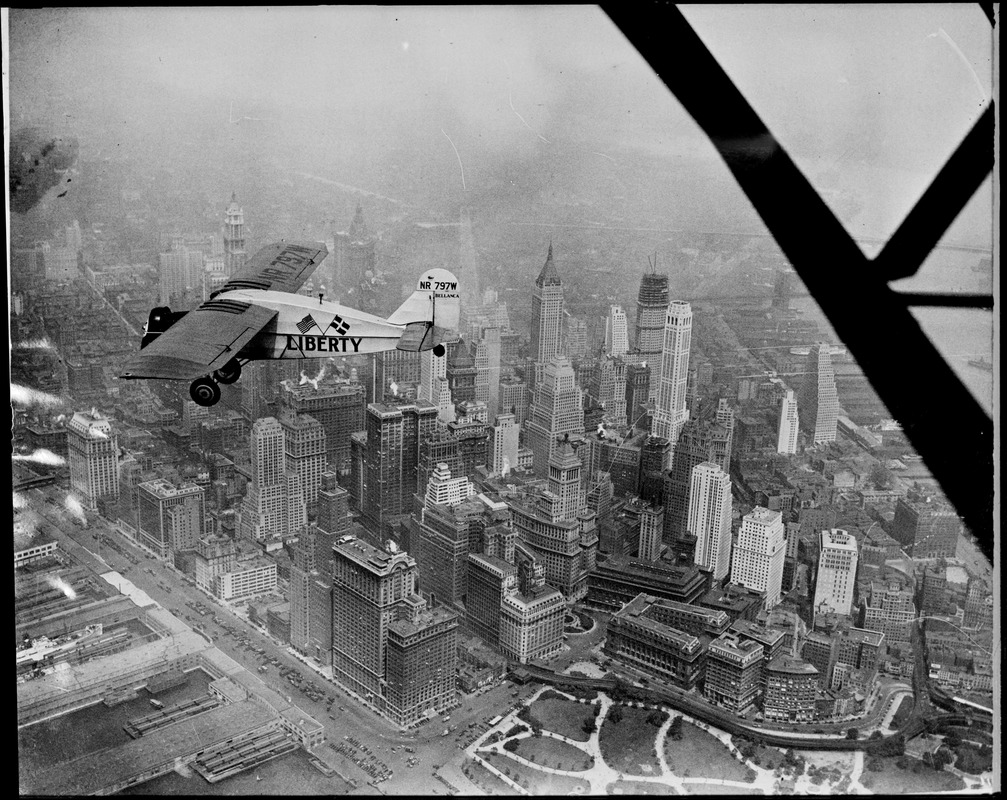 Liberty bellanca monoplane in the air (over NYC) on first leg of its flight to Denmark. From Hasbrouck Heights, N.J. with Otto Hillig of Liberty, N.Y., flying photographer and Capt. Hoérüs, the pilot.