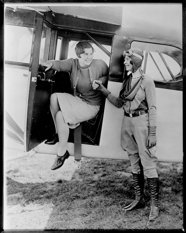 Miss Helen Hicks, 18-year-old golf star, and Elinor Smith, 17-year-old aviatrix, at Fairchild Field, Farmingdale, N.Y.